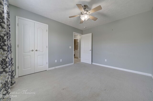 4704 Shannon Ln, Panama City, FL 32404 - unfurnished bedroom with a closet, baseboards, carpet flooring, and a textured ceiling