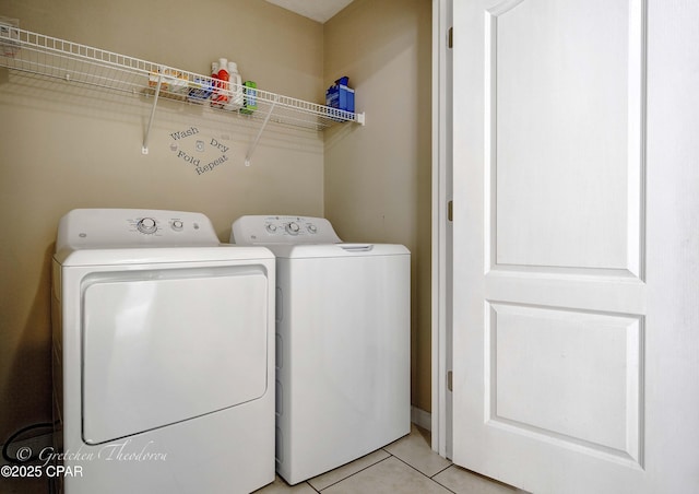 laundry room featuring laundry area, independent washer and dryer, and light tile patterned floors