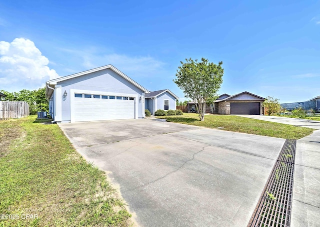 ranch-style home with concrete driveway, fence, and a front lawn