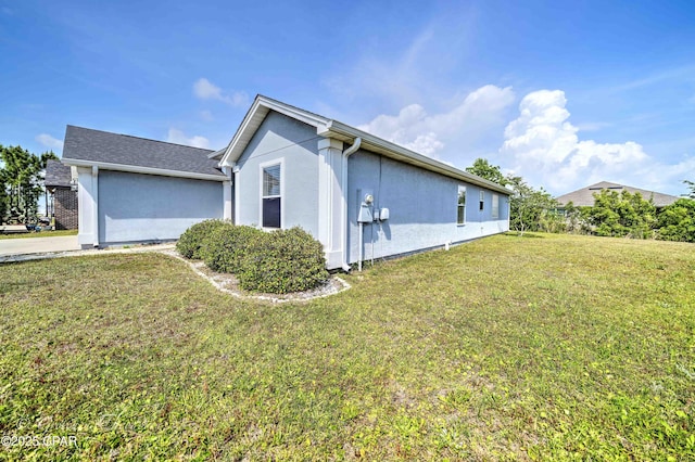 view of property exterior featuring a lawn and stucco siding