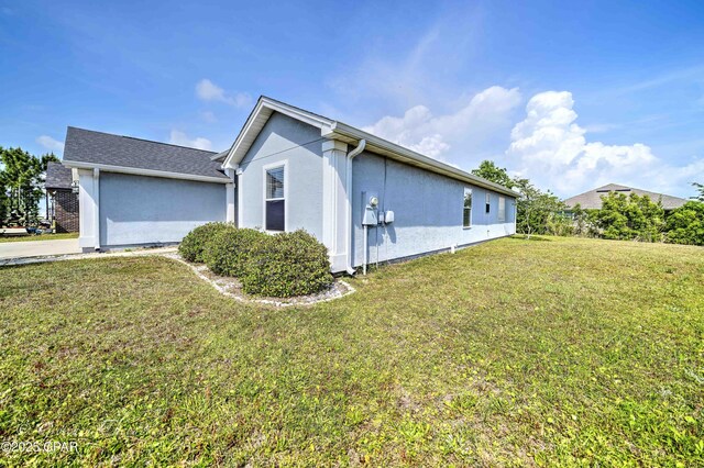 4704 Shannon Ln, Panama City, FL 32404 - view of property exterior featuring stucco siding and a yard