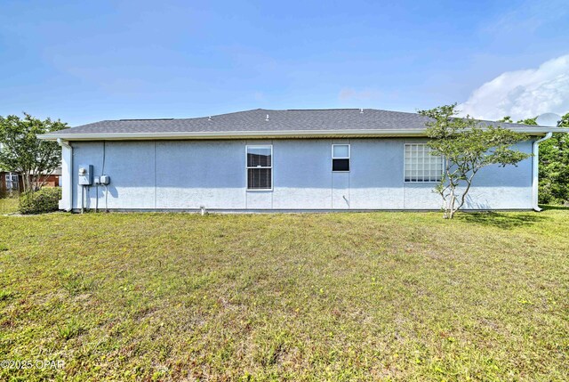 4704 Shannon Ln, Panama City, FL 32404 - back of property featuring a lawn and stucco siding