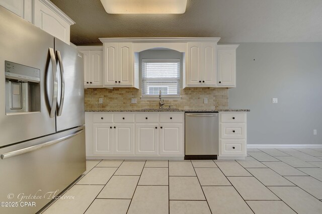 4704 Shannon Ln, Panama City, FL 32404 - kitchen featuring light stone counters, a sink, tasteful backsplash, and stainless steel appliances