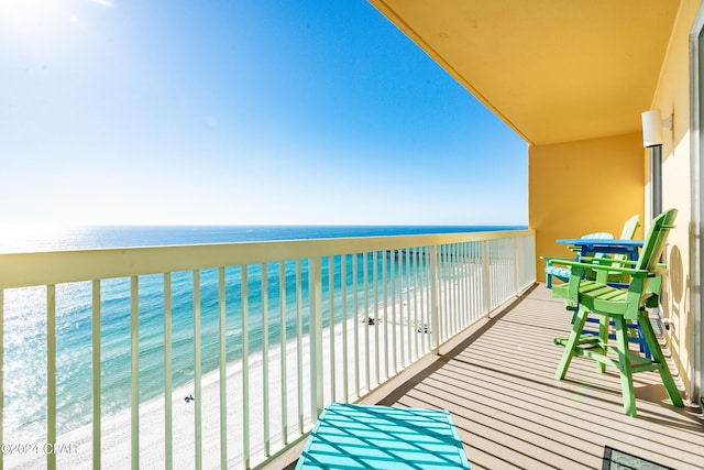 balcony featuring a water view and a view of the beach