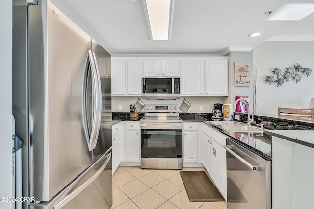 kitchen featuring a sink, light tile patterned floors, white cabinets, and stainless steel appliances
