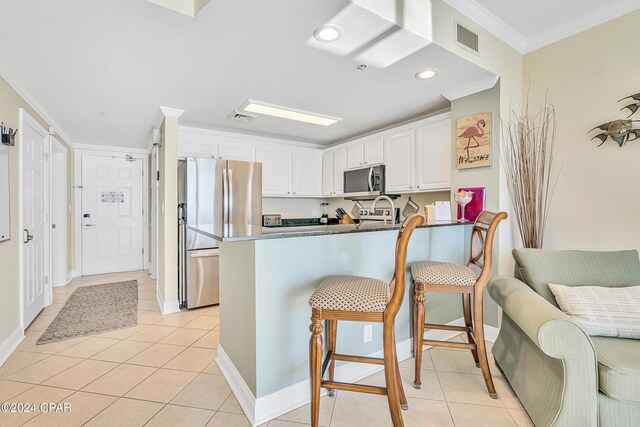15817 Front Beach Rd Unit 1-15O5, Panama City Beach, FL 32413 - kitchen featuring appliances with stainless steel finishes, a kitchen breakfast bar, a peninsula, white cabinetry, and visible vents