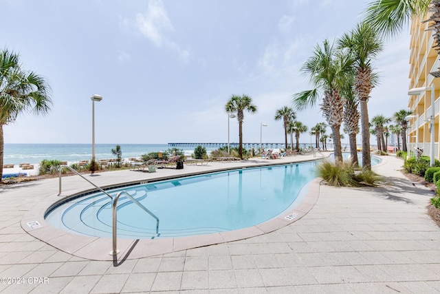 pool with a water view and a patio area