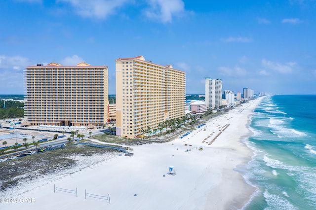 drone / aerial view with a beach view and a water view