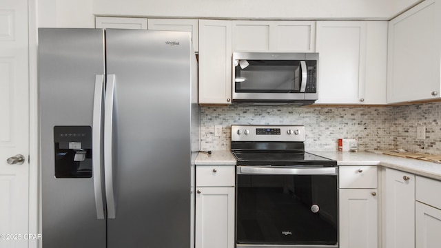 325 Bell Cir, Lynn Haven, FL 32444 - kitchen featuring appliances with stainless steel finishes, decorative backsplash, light countertops, and white cabinets