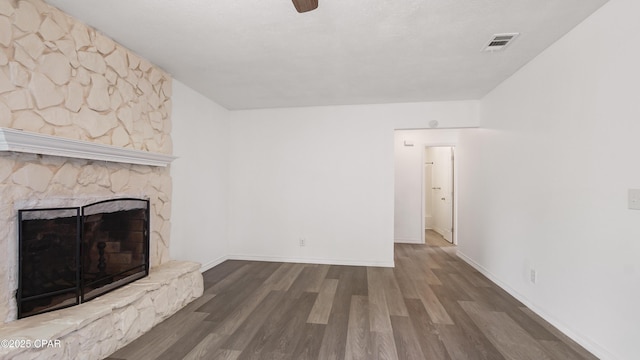 325 Bell Cir, Lynn Haven, FL 32444 - unfurnished living room featuring wood finished floors, a stone fireplace, baseboards, and ceiling fan