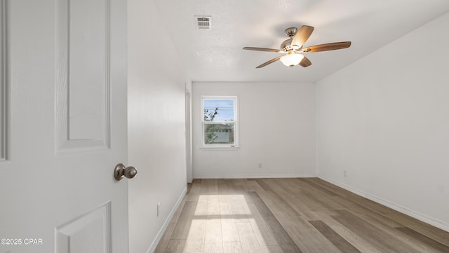 325 Bell Cir, Lynn Haven, FL 32444 - empty room with wood finished floors, ceiling fan, and baseboards