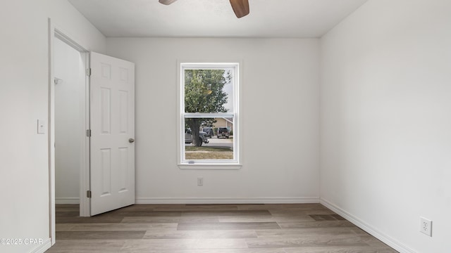 325 Bell Cir, Lynn Haven, FL 32444 - unfurnished bedroom with wood finished floors, ceiling fan, and baseboards