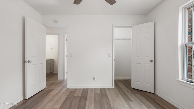 325 Bell Cir, Lynn Haven, FL 32444 - unfurnished bedroom featuring light wood finished floors, multiple windows, baseboards, and a closet