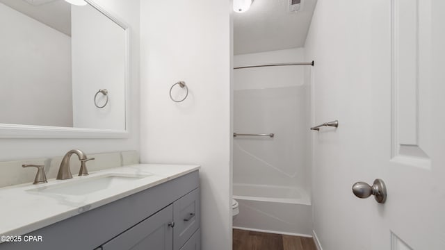 325 Bell Cir, Lynn Haven, FL 32444 - bathroom featuring wood finished floors, toilet, vanity, bathing tub / shower combination, and baseboards