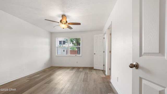 325 Bell Cir, Lynn Haven, FL 32444 - spare room with light wood-style flooring, ceiling fan, and baseboards