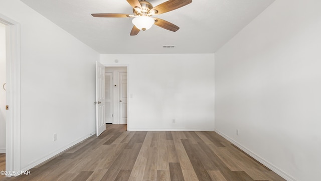 325 Bell Cir, Lynn Haven, FL 32444 - unfurnished bedroom featuring wood finished floors, baseboards, and ceiling fan