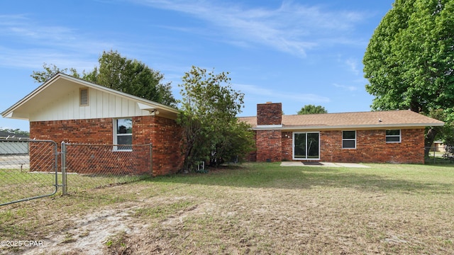 325 Bell Cir, Lynn Haven, FL 32444 - rear view of property featuring a chimney and brick siding