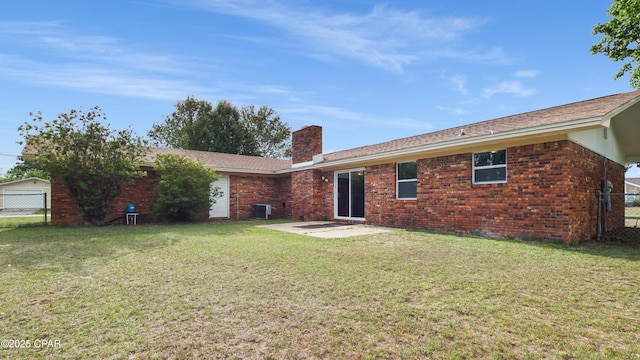 325 Bell Cir, Lynn Haven, FL 32444 - back of house with a chimney, a patio area, brick siding, and cooling unit