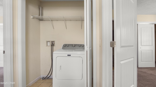 washroom featuring laundry area, light carpet, washer / clothes dryer, baseboards, and light tile patterned floors