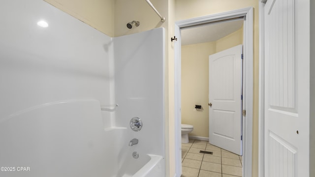 bathroom featuring tile patterned floors, bathtub / shower combination, and toilet