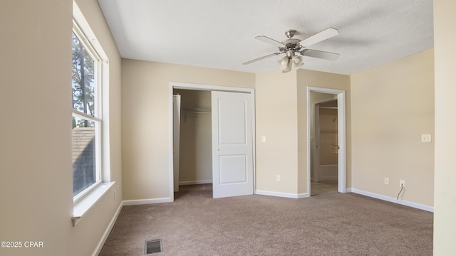 unfurnished bedroom with carpet floors, visible vents, and multiple windows