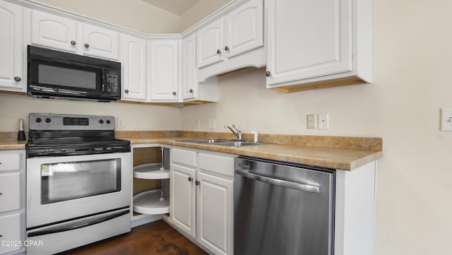 kitchen with a sink, appliances with stainless steel finishes, white cabinets, and light countertops
