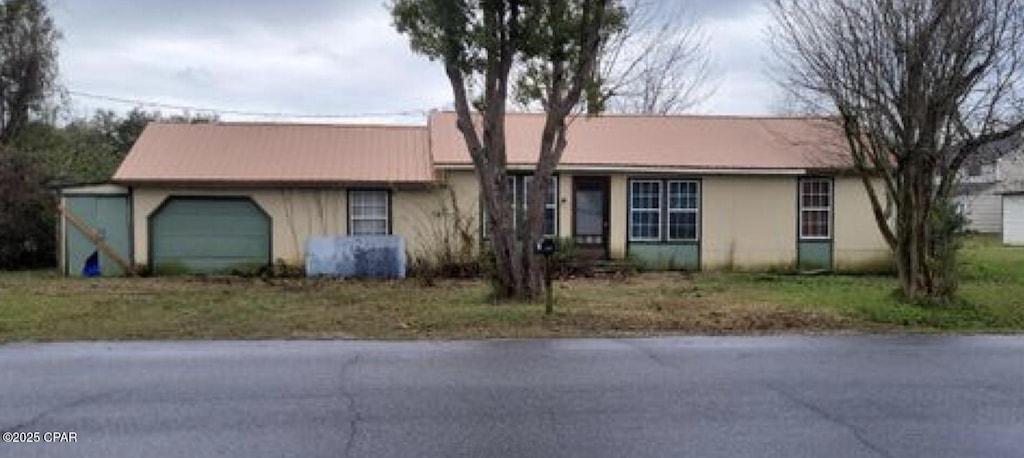 ranch-style house with a garage and stucco siding