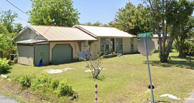 ranch-style home with an attached garage and a front lawn