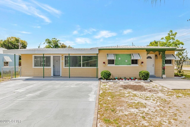 ranch-style home featuring concrete driveway