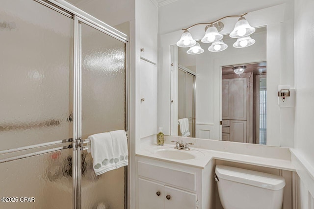 bathroom with toilet, a notable chandelier, a shower stall, and vanity