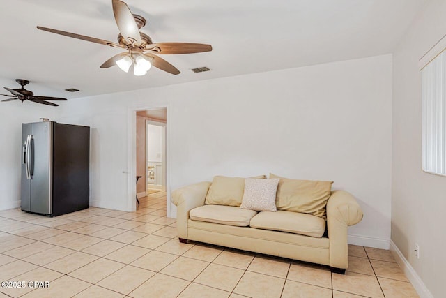 living room featuring light tile patterned floors, ceiling fan, and visible vents