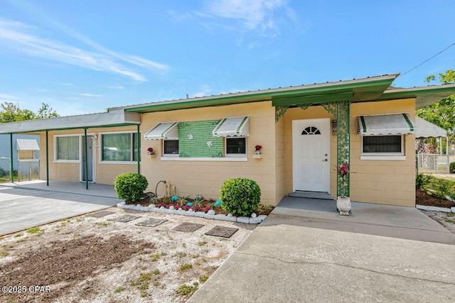 ranch-style house with metal roof