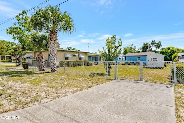 ranch-style house with a fenced front yard, a gate, and a front yard
