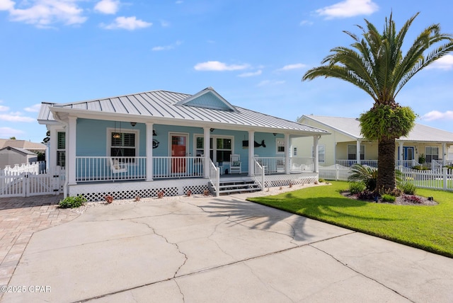 view of front of property with a porch, a standing seam roof, and metal roof