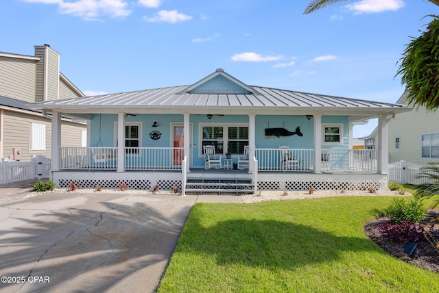 135 Bid A Wee Ln, Panama City Beach, FL 32413 - view of front facade featuring covered porch, a standing seam roof, metal roof, and a gate