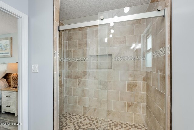 135 Bid A Wee Ln, Panama City Beach, FL 32413 - ensuite bathroom with a textured ceiling and a stall shower