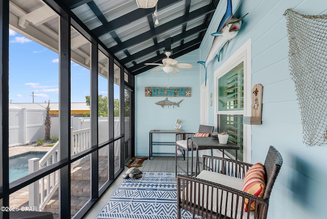 sunroom / solarium featuring a ceiling fan and vaulted ceiling