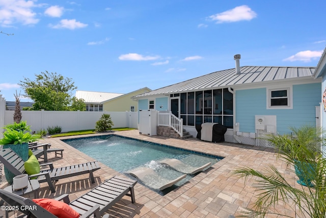 view of pool with a sunroom, a patio area, and a fenced backyard