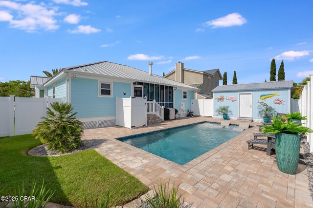 135 Bid A Wee Ln, Panama City Beach, FL 32413 - back of property featuring a standing seam roof, a patio area, metal roof, an outdoor structure, and a gate