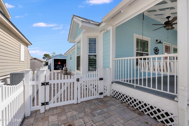 135 Bid A Wee Ln, Panama City Beach, FL 32413 - view of side of home featuring a gate, fence, and a ceiling fan