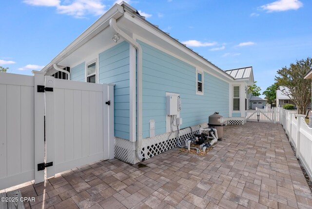 135 Bid A Wee Ln, Panama City Beach, FL 32413 - view of side of property featuring a gate, a patio area, and a fenced backyard