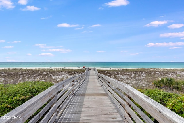 surrounding community featuring view of water and beach