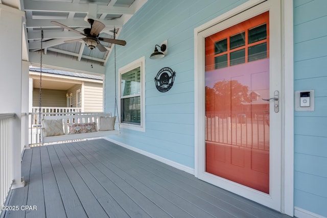 doorway to property with covered porch and ceiling fan