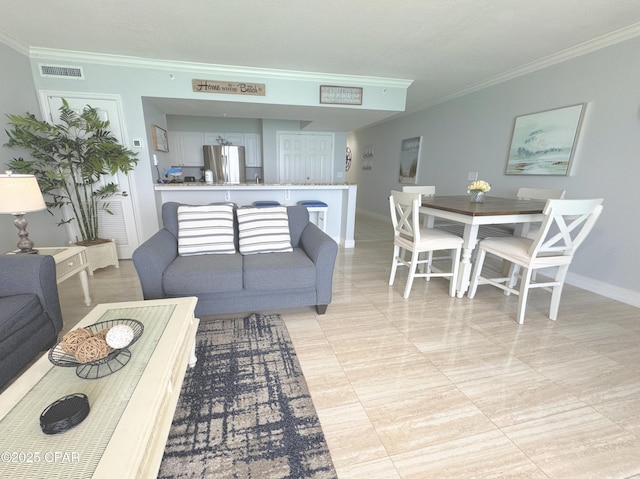 living room with visible vents, baseboards, and crown molding
