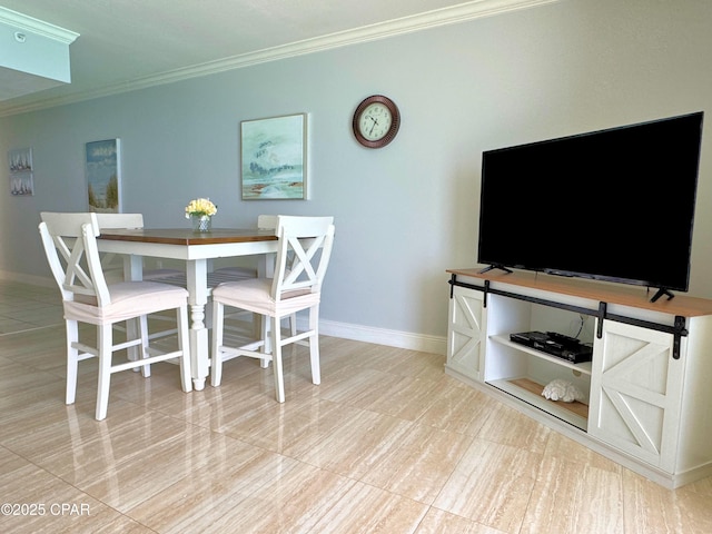 dining space with crown molding, baseboards, and tile patterned flooring