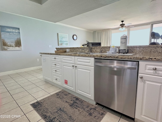 kitchen with stainless steel dishwasher, crown molding, a ceiling fan, white cabinets, and a sink