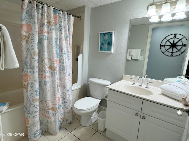bathroom featuring shower / bath combo, tile patterned flooring, vanity, toilet, and a drop ceiling