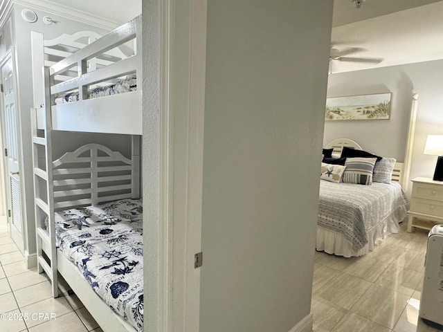 bedroom with light tile patterned floors and crown molding
