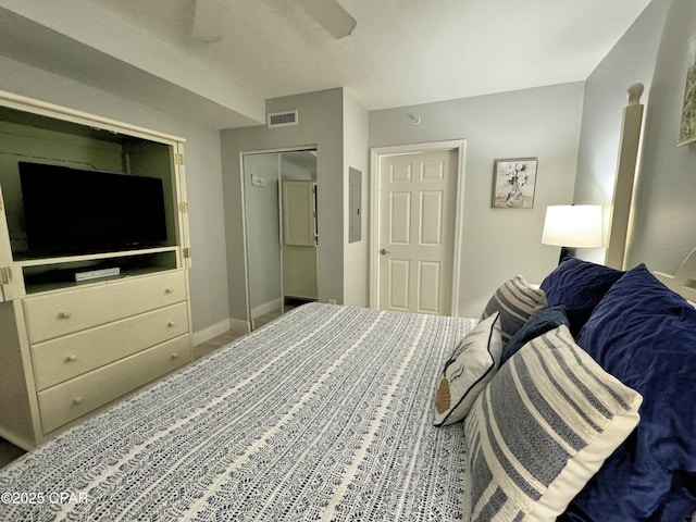 bedroom featuring baseboards, a ceiling fan, and visible vents