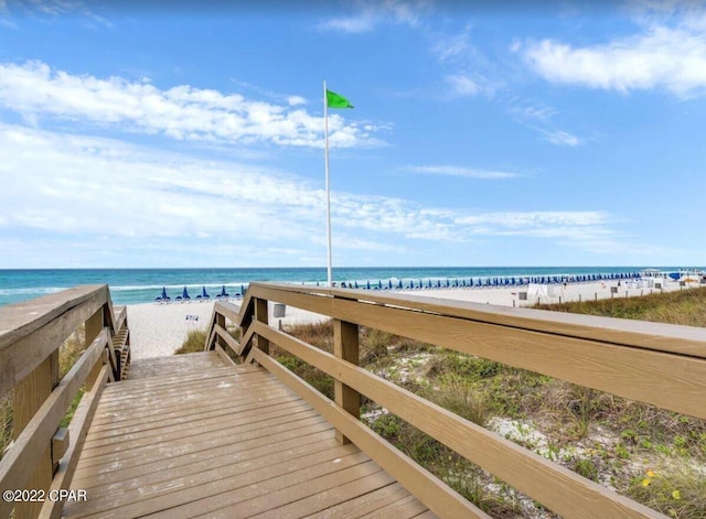 view of property's community featuring a water view and a view of the beach